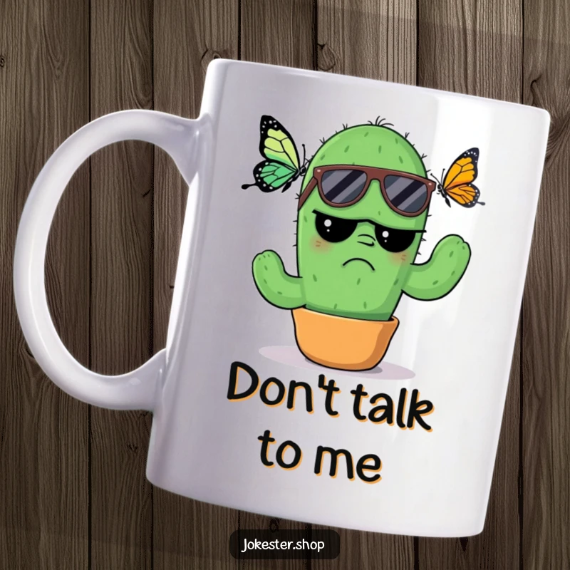 Funny Mug: A grumpy cactus wearing sunglasses, looking annoyed as a butterfly flutters nearby, embodying a cool yet irritated vibe.