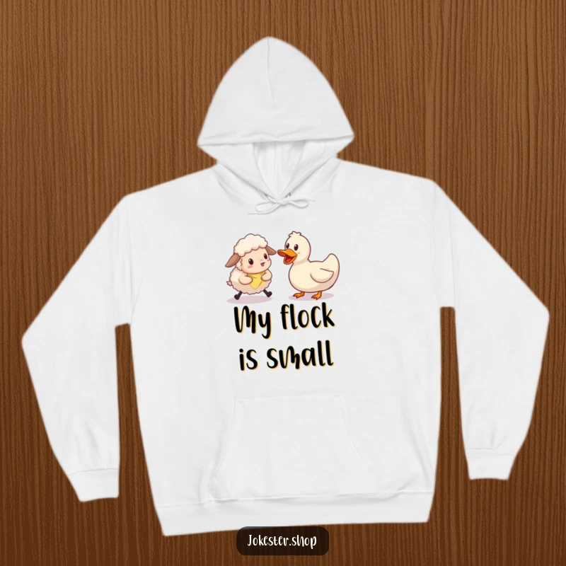 Funny sheep character looking bewildered while trying to herd a single, unmoving rubber duck. A warm and funny hoodie for relatable humor.
