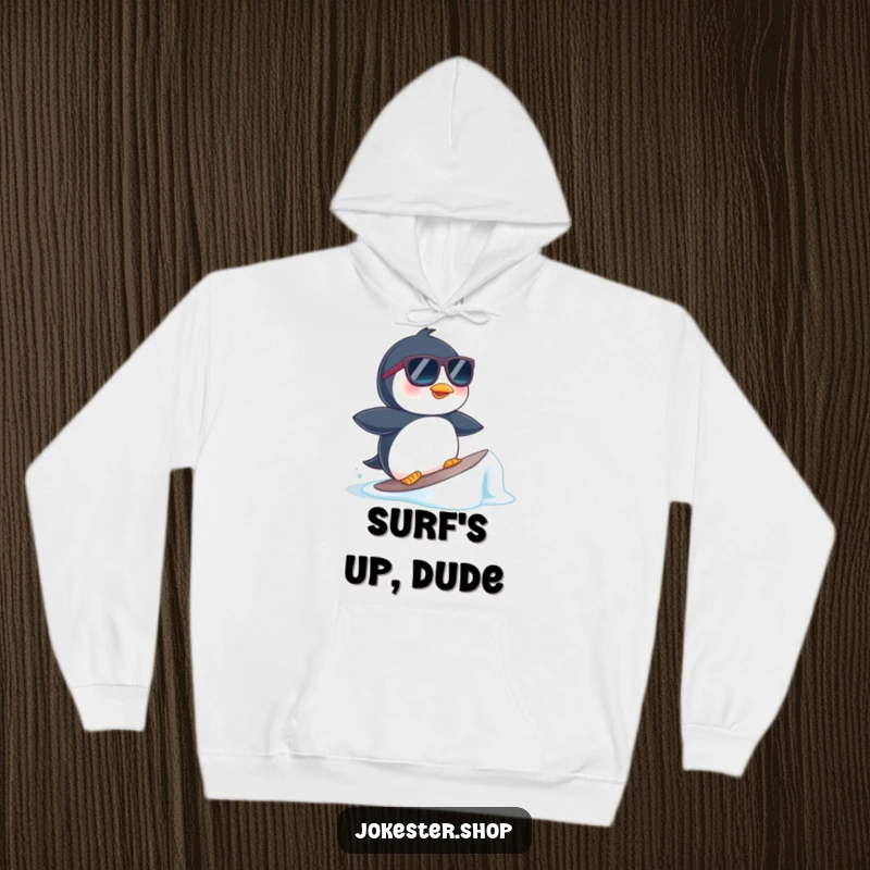 Funny hoodie print of a cool penguin in sunglasses surfing a tiny ice floe, radiating relaxed beach energy.